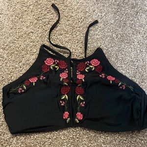 Black high cut bathing suit top with rose detail